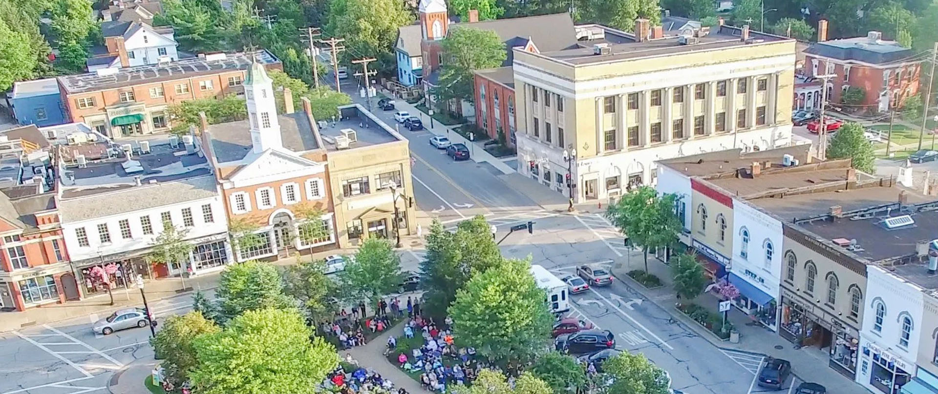 Aerial view of downtown Chagrin Falls, Ohio, on a sunny day. Concert attendees gather in Triangle Park.