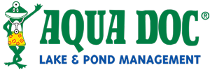 Logo for Aqua Doc Lake & Pond Management featuring a cartoon frog wearing shorts and a stethoscope, surrounded by flowers to evoke the Blossom Time, with the company name in bold green letters.