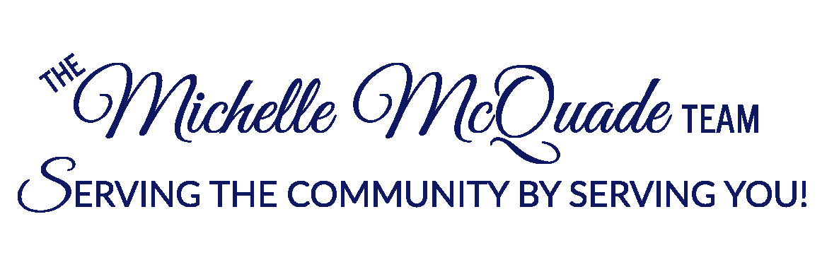 Logo for "The Michelle McQuade Team" with the tagline "Serving the community by serving you!" in blue cursive and uppercase letters.